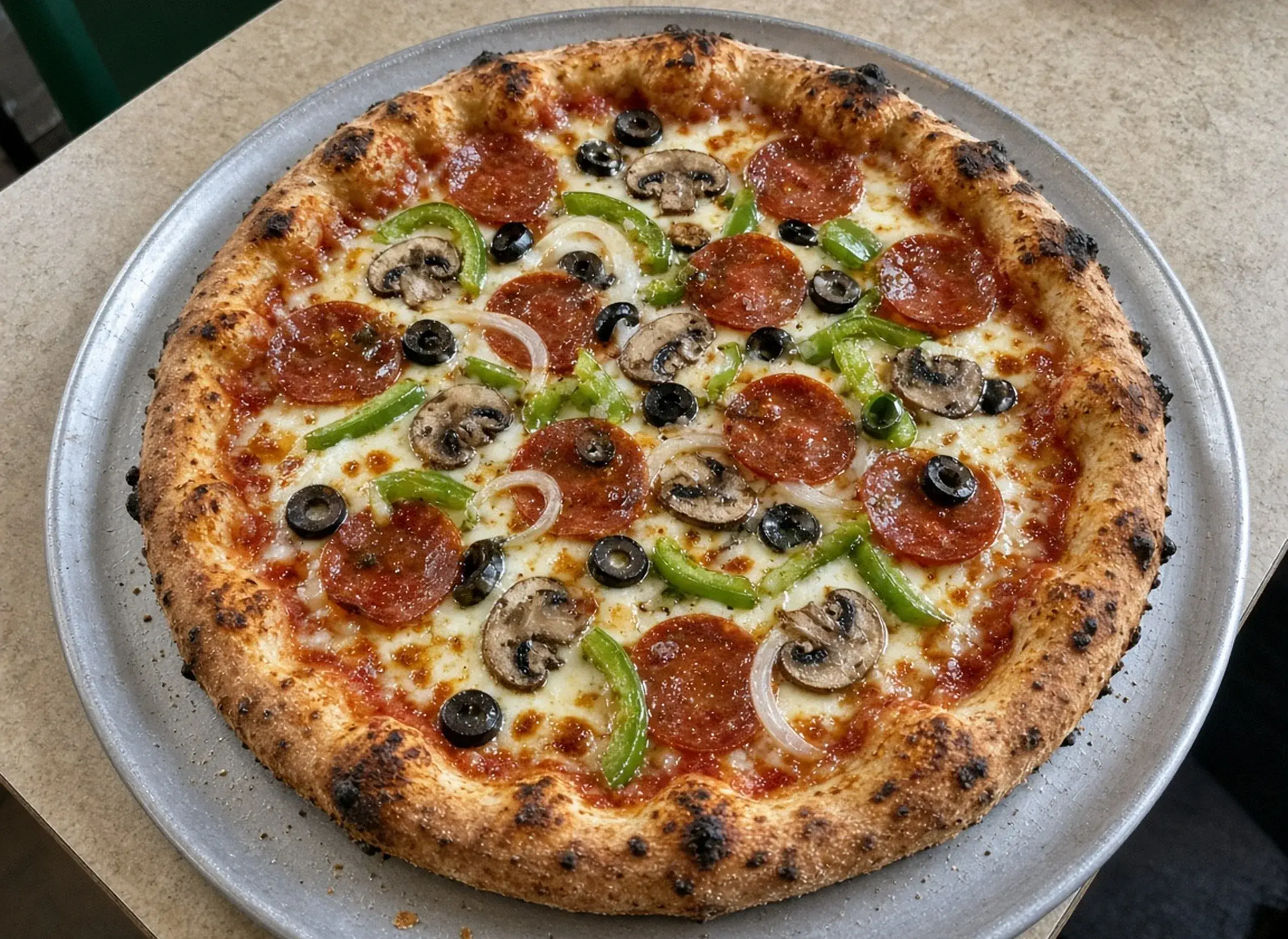 Loaded combination pizza with vegetables and pepperoni
