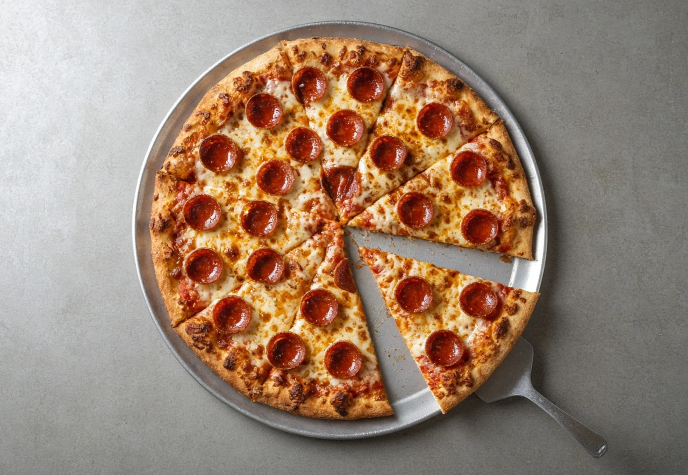 New York-style pepperoni pizza with a separated slice